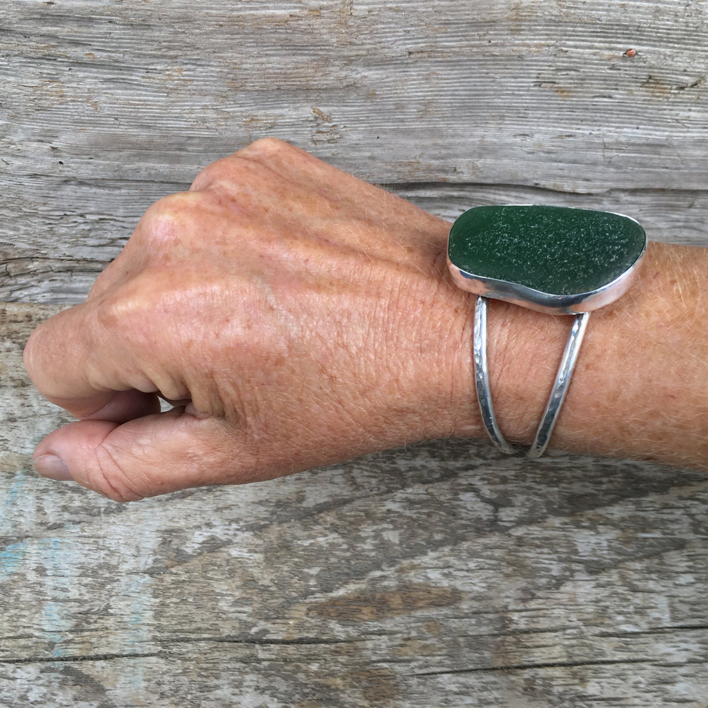 Luxe Beachcomber Cuff with Extra Large Deep Green Seaglass Shown on Wrist at Angle