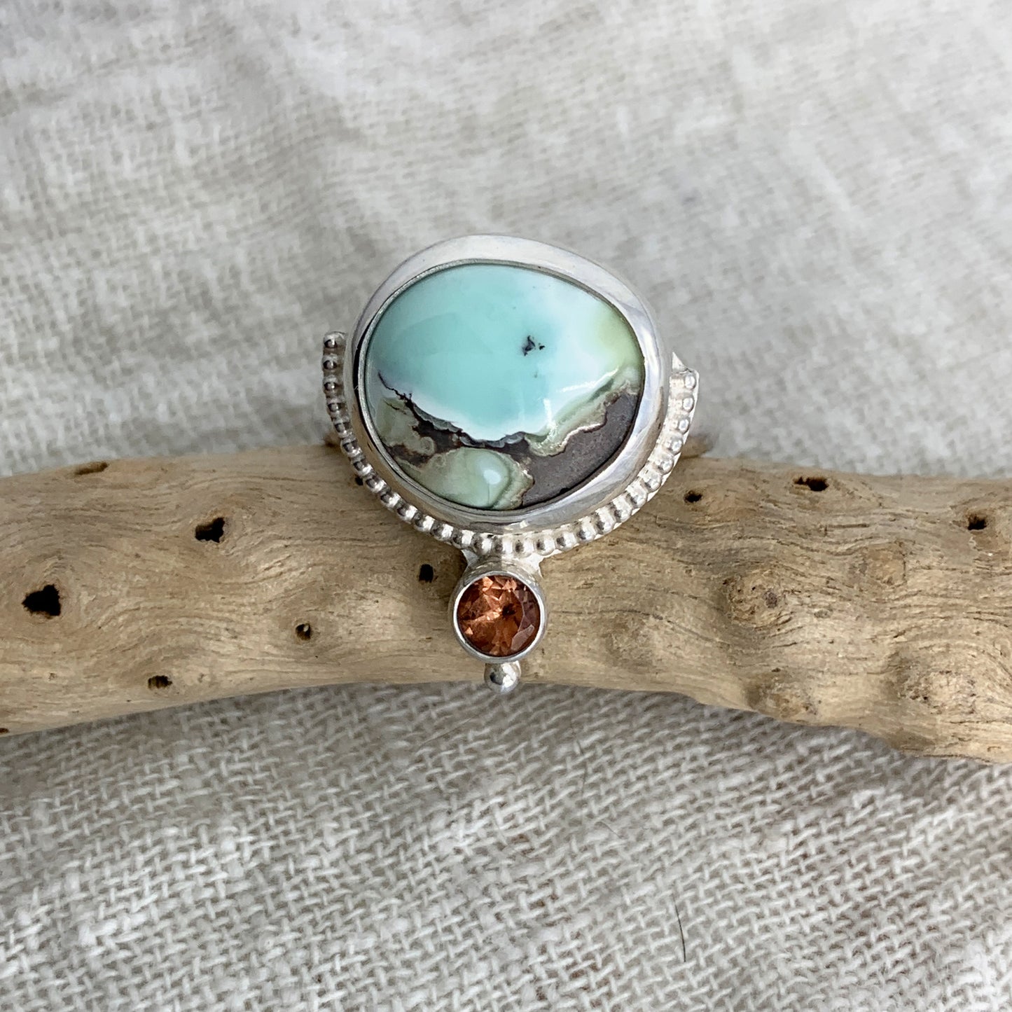 Hand fabricated, two stone, moderate statement ring featuring a stunning Poseidon Variscite cabochon paired with a bright, faceted pink/peach Tourmaline and silver raindrop and beaded wire details.