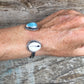 Two Treasures Cowry Shell and Larimar Cuff Shown on Hand
